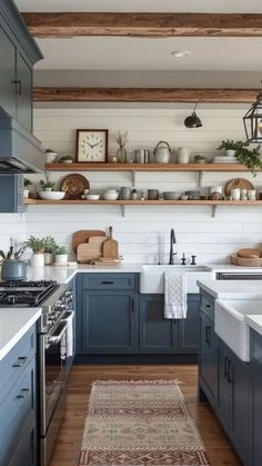 a kitchen with blue cabinets and white counter tops, wooden shelves above the stovetop