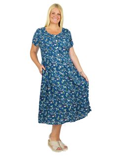 You'll love this scoop neck full button-front dress by La Cera. Soft rayon fabric is blanketed with botanical florals to make this retro-style dress perfect for casual or dressier occasions. And the empire waist is so figure flattering! Details include side seam pockets, and back tie to adjust fit. Style: Short Sleeve Button-FrontMaterial: 100% RayonCare Instruction: Machine Wash; Hang to dryCountry of Origin: India Color: TealLength: 50" from top to hem Model Number: 2744X/3935 Retro Style Dress, India Colors, Button Front Dress, Rayon Fabric, Short Sleeve Dress, Fit Style, Style Dress, Empire Waist, Plus Size Dresses