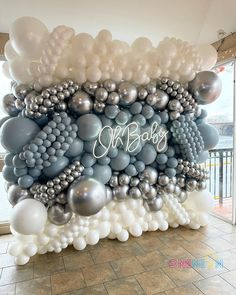 a large balloon wall with balloons and the words mr bob's on it in white, grey and silver