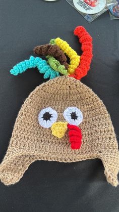 a crocheted turkey hat on top of a table