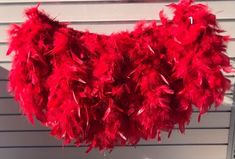 red feathers hanging from the side of a building