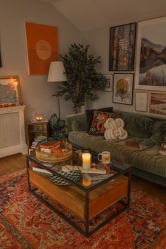 a living room with a couch, coffee table and pictures on the wall above it