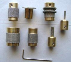 several different types of brass fittings on a white surface