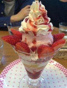 an ice cream sundae with strawberries on top