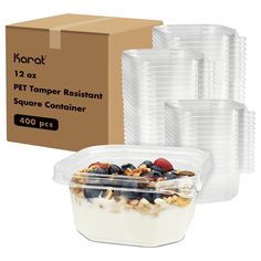 several plastic containers filled with food next to a cardboard box