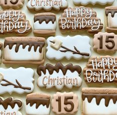 decorated cookies with icing and frosting are arranged in the shape of a birthday cake