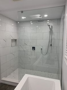 a bathroom with a walk in shower next to a bath tub