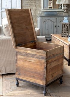 an old trunk sitting on top of a hard wood floor next to a white couch