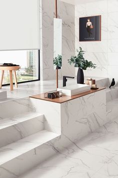 a bathroom with white marble walls and flooring