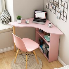 a pink corner desk with a laptop on it