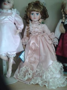 three dolls are sitting next to each other