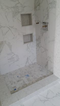 a bathroom with marble walls and flooring in the shower area is seen here, it appears to be being remodeled or remodeled