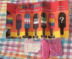 an assortment of popsicles on a plaid blanket