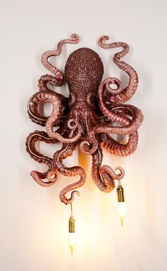 an octopus lamp with two lights attached to it's body and tentacles hanging from the wall