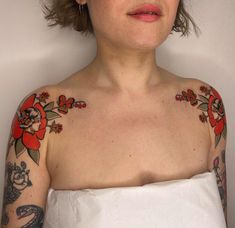 a woman with tattoos on her arms and chest is looking at the camera while wearing a white dress