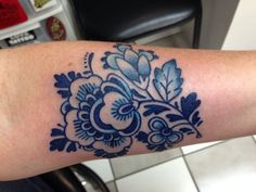 a close up of a person's arm with a tattoo design on the arm