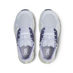 a pair of white and blue sneakers on a white background with the word on it