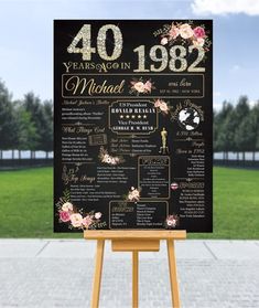 a sign with flowers on it that says 40 years ago in black and gold lettering