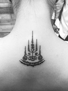 the back of a woman's neck with an intricate design on it