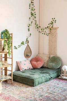 a living room filled with lots of furniture and plants on top of the wall next to a rug