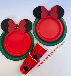 a mickey mouse party set with plates, cups and candy canes