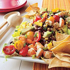 a white plate topped with salad and tortilla chips