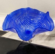 a blue glass bowl sitting on top of a counter