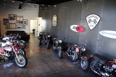 several motorcycles are lined up against the wall