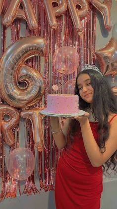 a woman in a red dress holding a cake