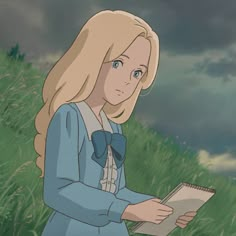 a woman standing in the grass holding a book and looking down at her left hand