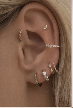 an ear with three different types of piercings on it