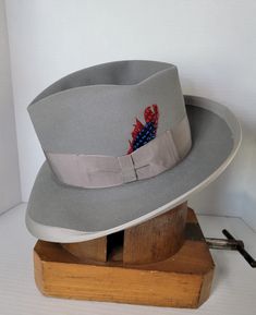 "Elevate your style with this beautiful vintage Knox's wide brimmed fedora hat. Crafted from high-quality materials, this hat is the perfect addition to any wardrobe. With its classic design and versatile color, make it a must-have for any fashion-forward individual who wants to make a statement. Its timeless design and superior craftsmanship ensure that it will be a staple in your wardrobe for years to come. Invest in this vintage accessory today and add a touch of sophistication to your look. Custom Formal Hat With Short Brim, Custom Wide Brim Fedora For Formal Occasions, Formal Wide Brim Fedora, Custom Adjustable Fedora For Formal Occasions, Adjustable Fedora For Formal Occasions, Custom Formal Hat For Kentucky Derby, Custom Hat For Kentucky Derby, Classic Fitted Gray Fedora, Custom Fitted Brimmed Hat