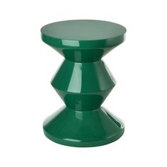 a small green stool sitting on top of a white floor