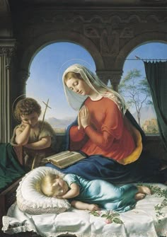 the virgin and child are laying in bed with an open book next to each other