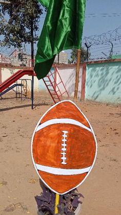 an orange and white football sitting on top of a pile of trash