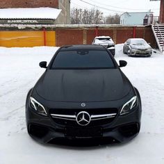 a mercedes benz coupe parked in the snow