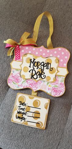 a sign that says morgan rae next to a tag with scissors and a bow on it