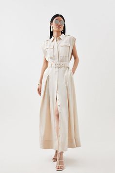 Elegant Styling Meets Timeless Tailoring For This Perfectly-Proportioned Hybrid Design, Crafted From Lightweight Linen That Beckons To Summer Styling. This Maxi Dress Is Structured With Classic Details, Including Wide Shoulders That Create Soft Drapes To The Button-Up Bodice, Offset By A Belted Waist And Inverted Pleats.Point Collarbuttoned Placketchest Pocketsbelted Waistmaxi Length Sleeveless Shirt Dress Outfit, Elegant Styling, Latest Maxi Dresses, Wide Shoulders, Shirt Dress Outfit, Maxi Dress Collection, Summer Styling, Shirt Dress Summer, Sleeveless Shirt Dress