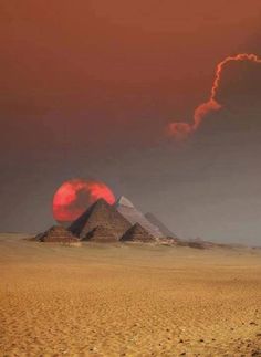 two pyramids in the desert under a red sky with clouds and sun behind them