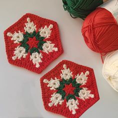 two crocheted hexagons sitting next to each other on a table