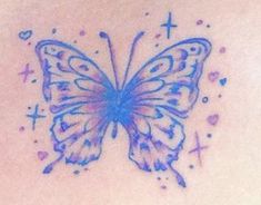 a blue butterfly tattoo on the back of a woman's upper arm and chest