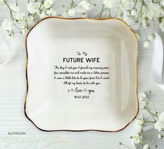 a white and gold plate with the words, future wife on it next to flowers