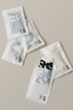 three clear bags with black and white designs on them