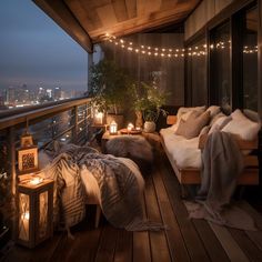 the balcony is decorated with lights and blankets on it's wooden floor, along with two couches that are facing each other