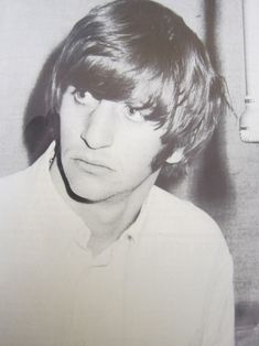 an old photo of a young man in a white shirt