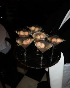 a table topped with martini glasses filled with eggs