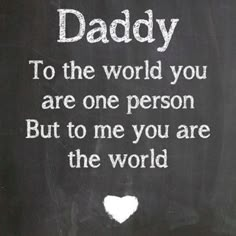 a teddy bear sitting in front of a chalkboard with the words daddy to the world you are one person but to me you are the world