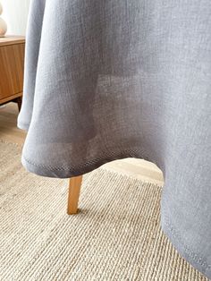 a close up view of the back of a bed with a gray cover over it