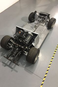 an image of a car that is on the ground with some wheels attached to it