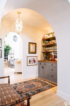 an archway leads to the living room and kitchen